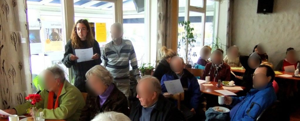 Angélique Olivia standing with a song sheet in a singing group, in a café